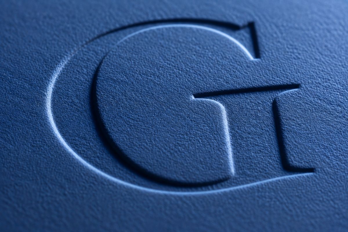Close-up of a debossed monogram on blue card stock
