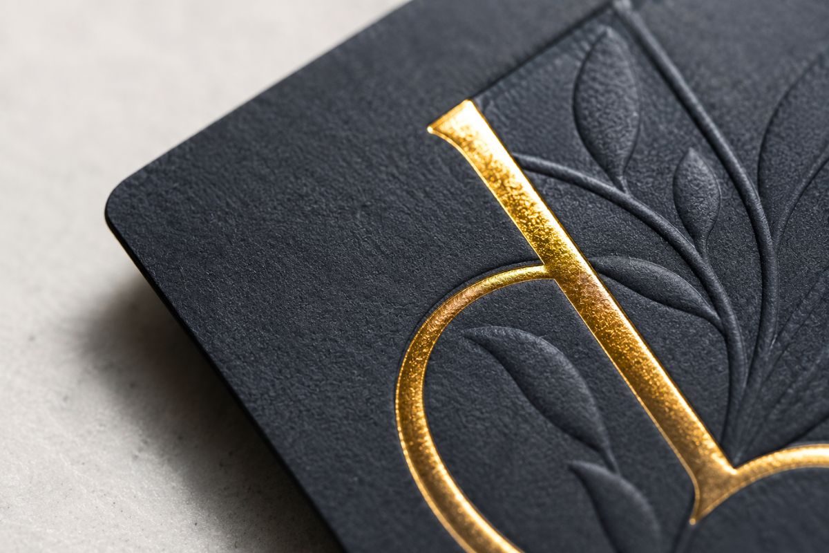 Close-up of gold foil and emboss finish on a business card